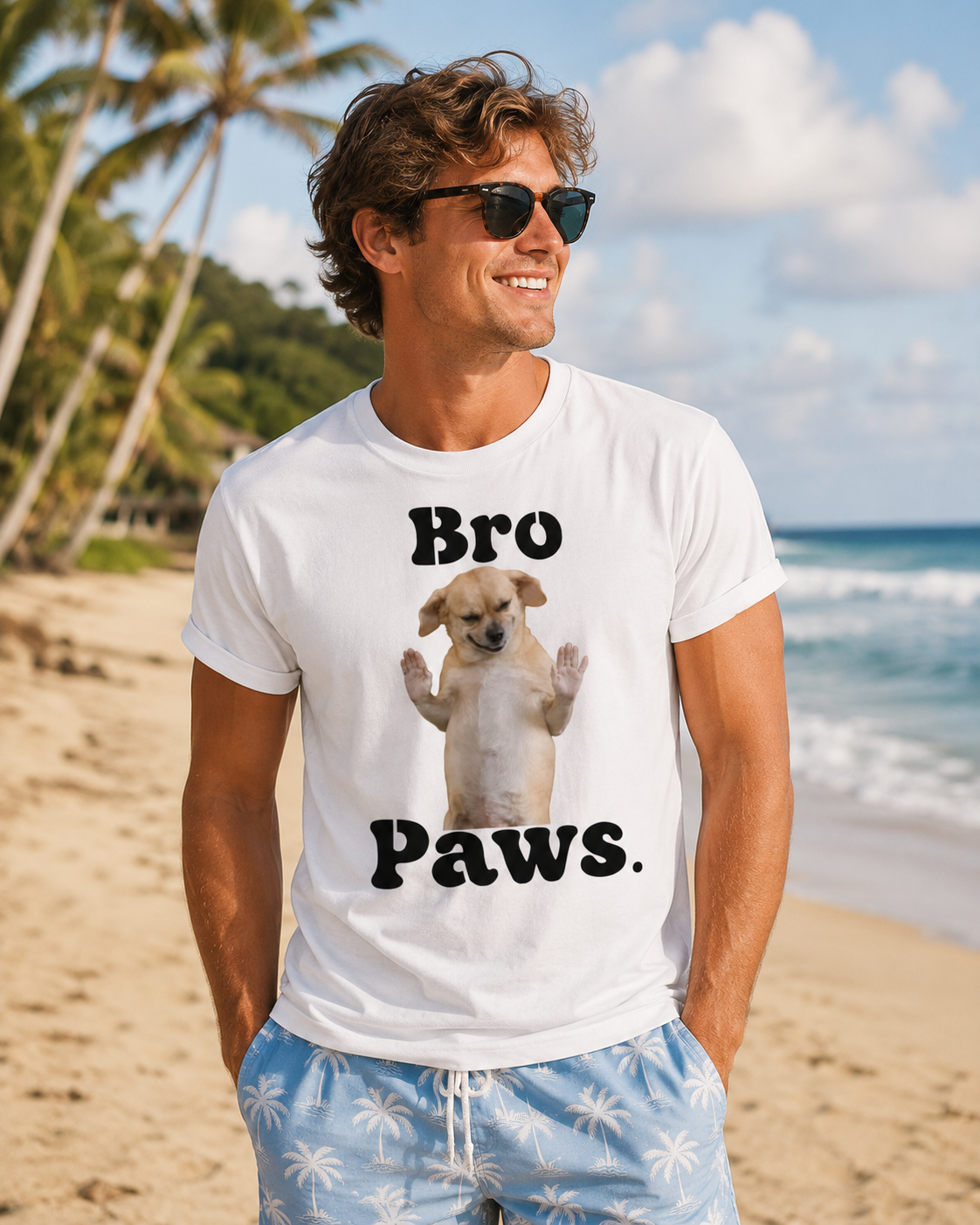 Man wearing a white t-shirt with a dog graphic and text on a beach.