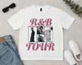 White t-shirt with 'R&B Tour' design featuring images of people, sunglasses, jeans, and sneakers on a light gray background.