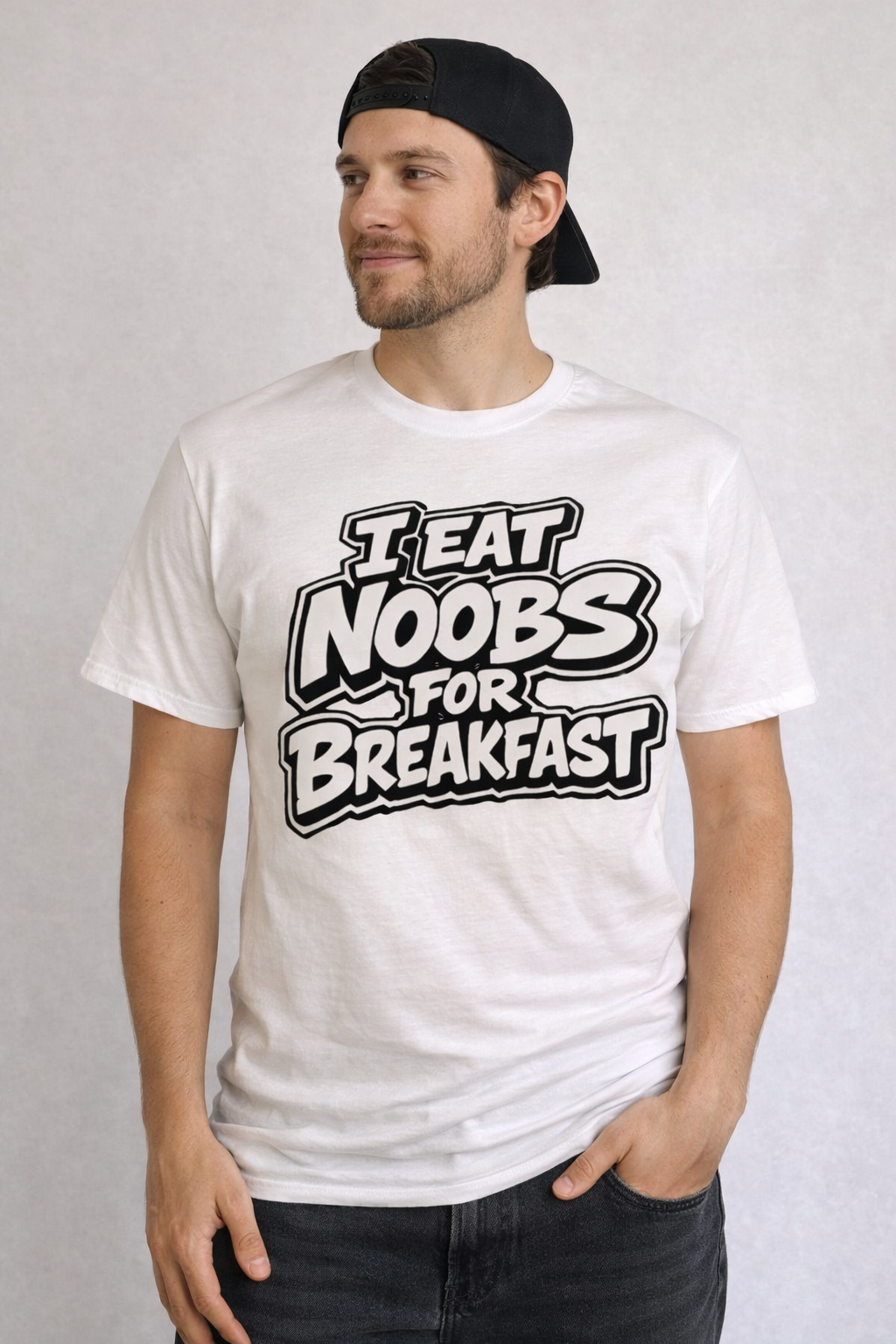 Man wearing a white t-shirt with 'I Eat Noobs for Breakfast' text on a plain background