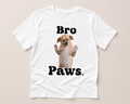 White t-shirt with a dog graphic and 'Bro Paws' text on a beige background